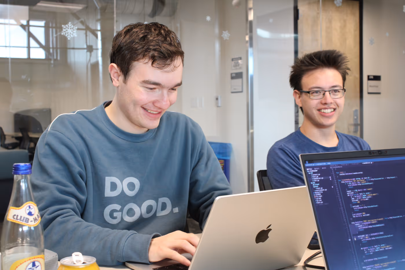 Lukas and I work on our laptops in a nice campus building. We are both smiling.