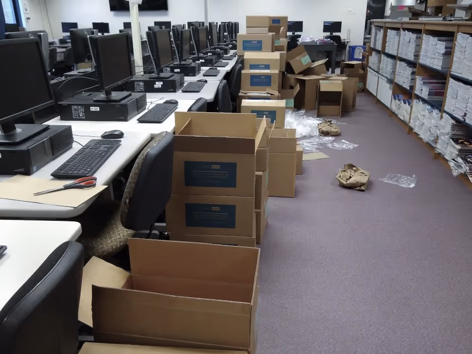 piles of boxes labeled Pre-AP strewn across a computer lab