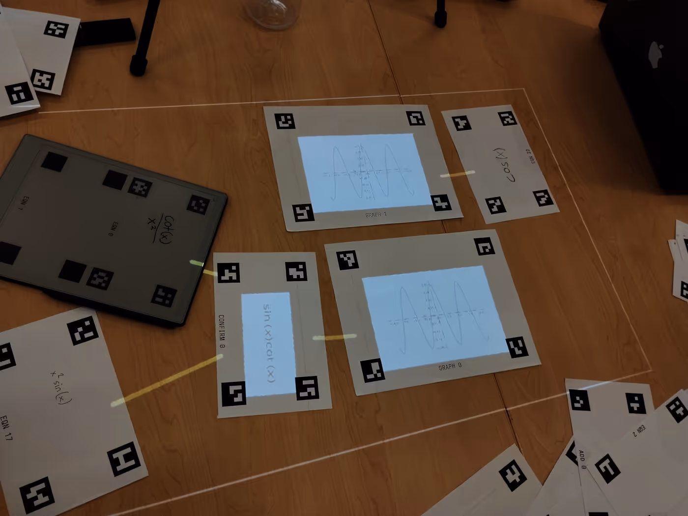 multiple cards laid out on a table with graphics projected on and between them